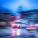 an ambulance racing through the rain an ambulance racing through the rain