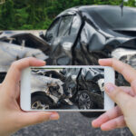 woman using smartphone take photo of car crash accident on the road woman using smartphone take photo of car crash accident on the road