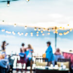 Defocused people attending open air summer party on the roof top. Warm sun light in the evening. Defocused people attending open air summer party on the roof top. Warm sun light in the evening.