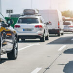 Car rush hours city street. Cars on highway in traffic jam Car rush hours city street. Cars on highway in traffic jam